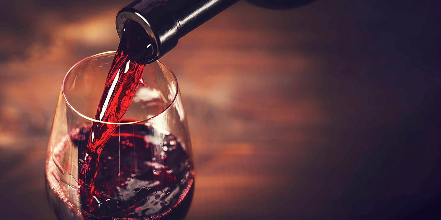 Pouring red wine into a glass